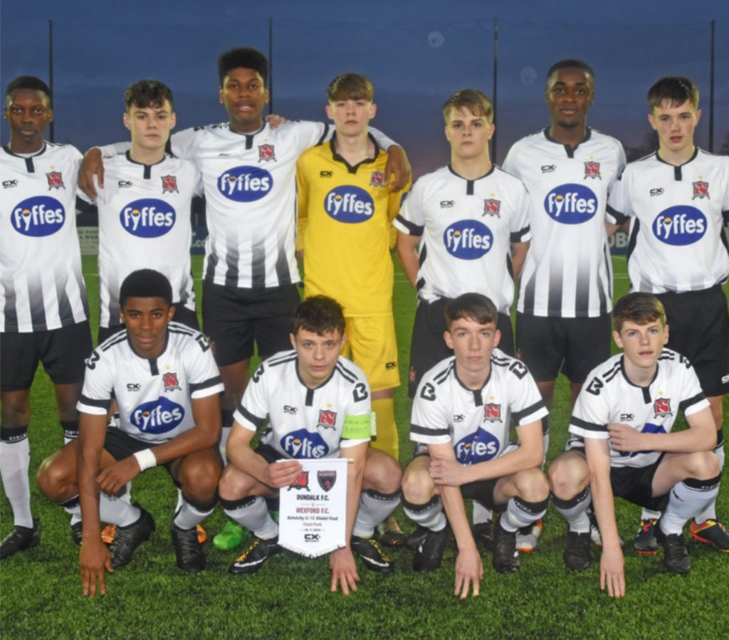 Jonathan Masueme with his football team